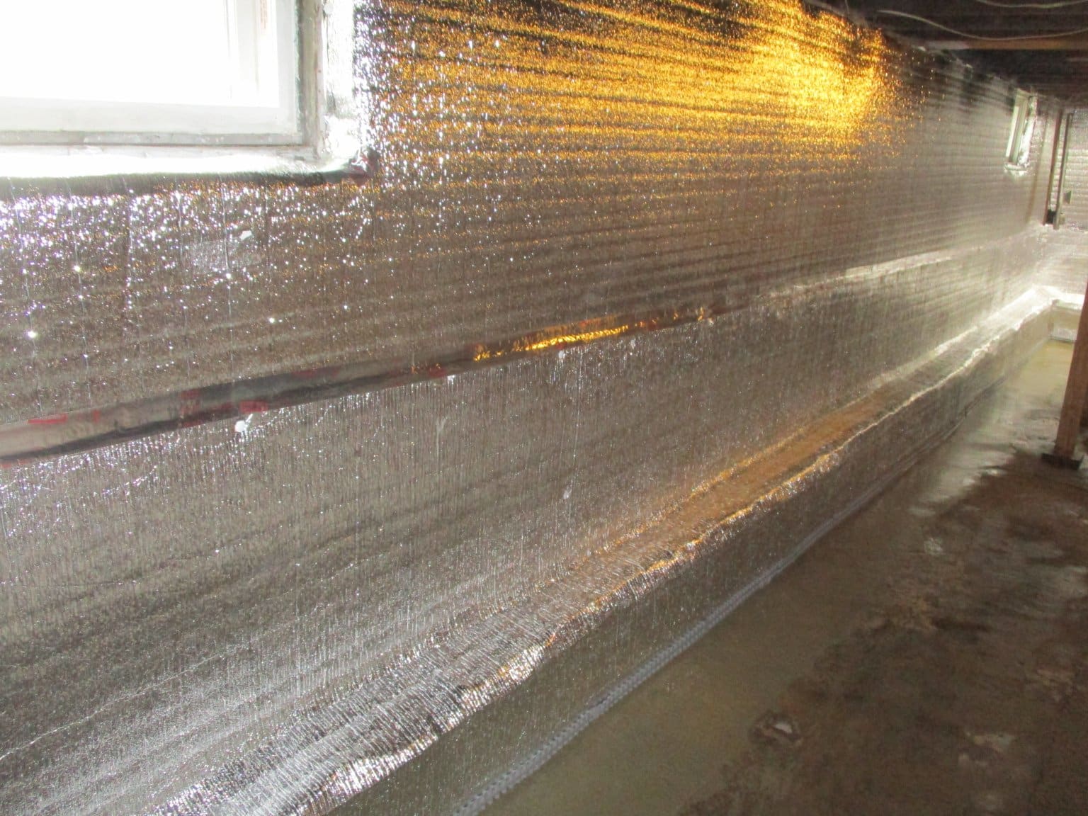 Aqua waterproofing crew installing basement drainage system in Bristol, PA
