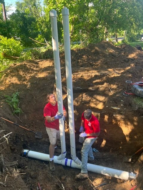 Brett Sabol Plumbing crew setting new PVC pipe near Washington Crossing, PA